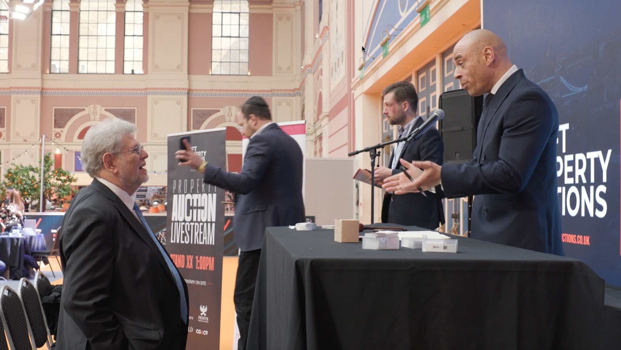 A visitor speaking with the Swift auction team at a property event