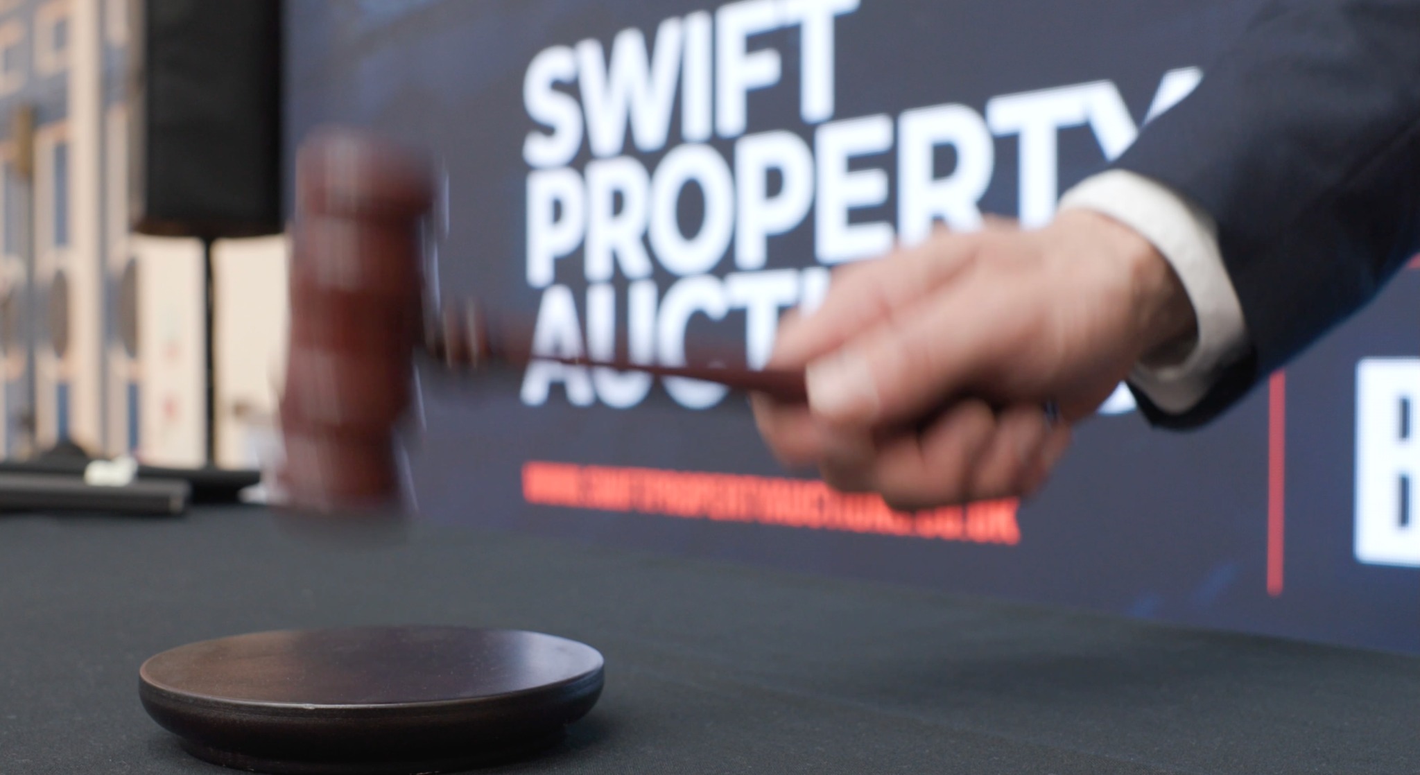 The auctioneer bringing down the gavel at a Swift property auction