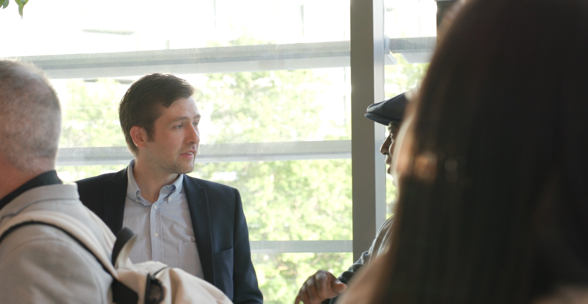 A member of the Swift team speaking with visitors at a property event
